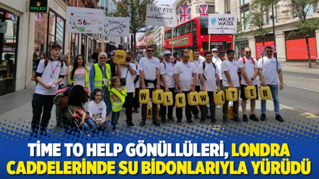 Time to Help gönüllüleri, Londra caddelerinde su bidonlarıyla yürüdü