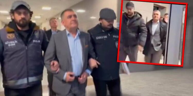 Orhan Turan savcılığa götürülürken eli cebine girdiği görüntü iktidarı öfkelendiriyor, polislerin koluna girmesi cezalandırmak için